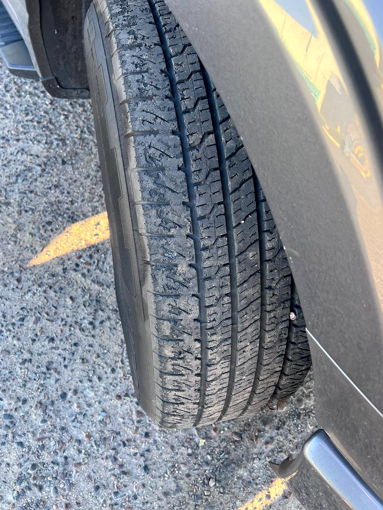 Close-up of a fresh tire tread on a gray pickup at the shop