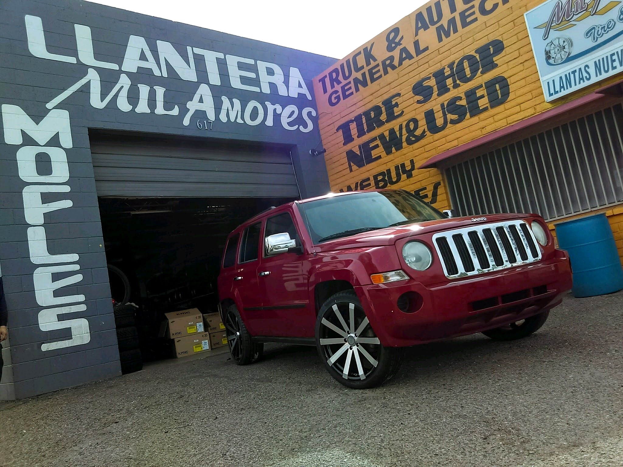 Red Jeep in front of the shop bays
