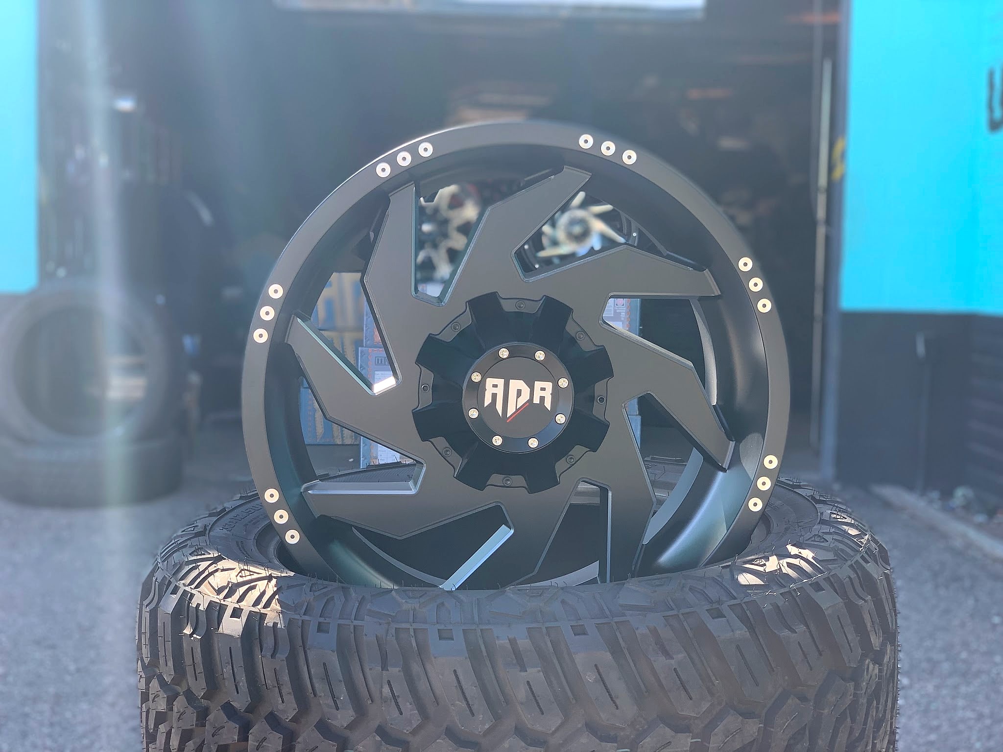 Machined custom wheel standing on an off-road tire